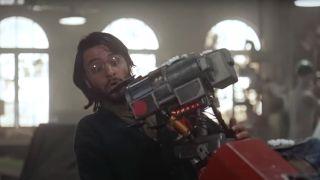 Fisher Stevens looks at Johnny 5 in surprise as he hugs him in Short Circuit 2.