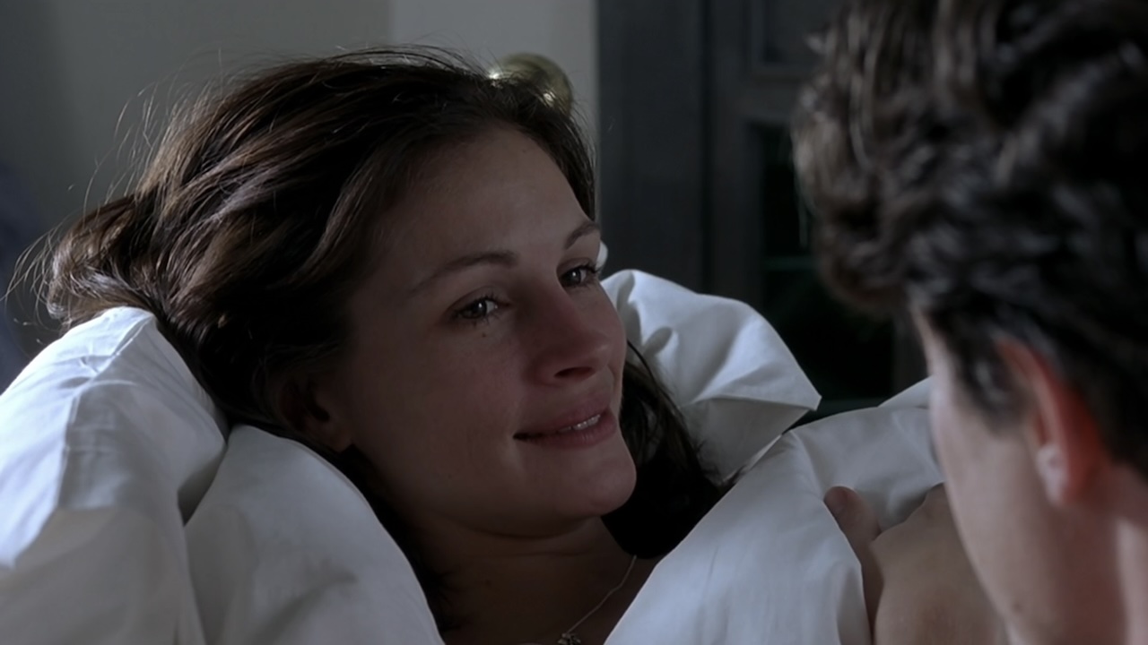 Anna smiling at Will in bed in Notting Hill