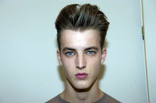 Male model head shot with hair voluminous and slicked back