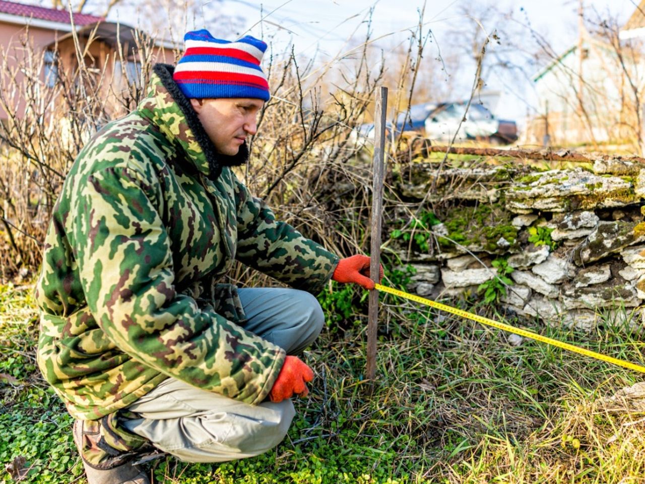 Person Measuring For A Garden