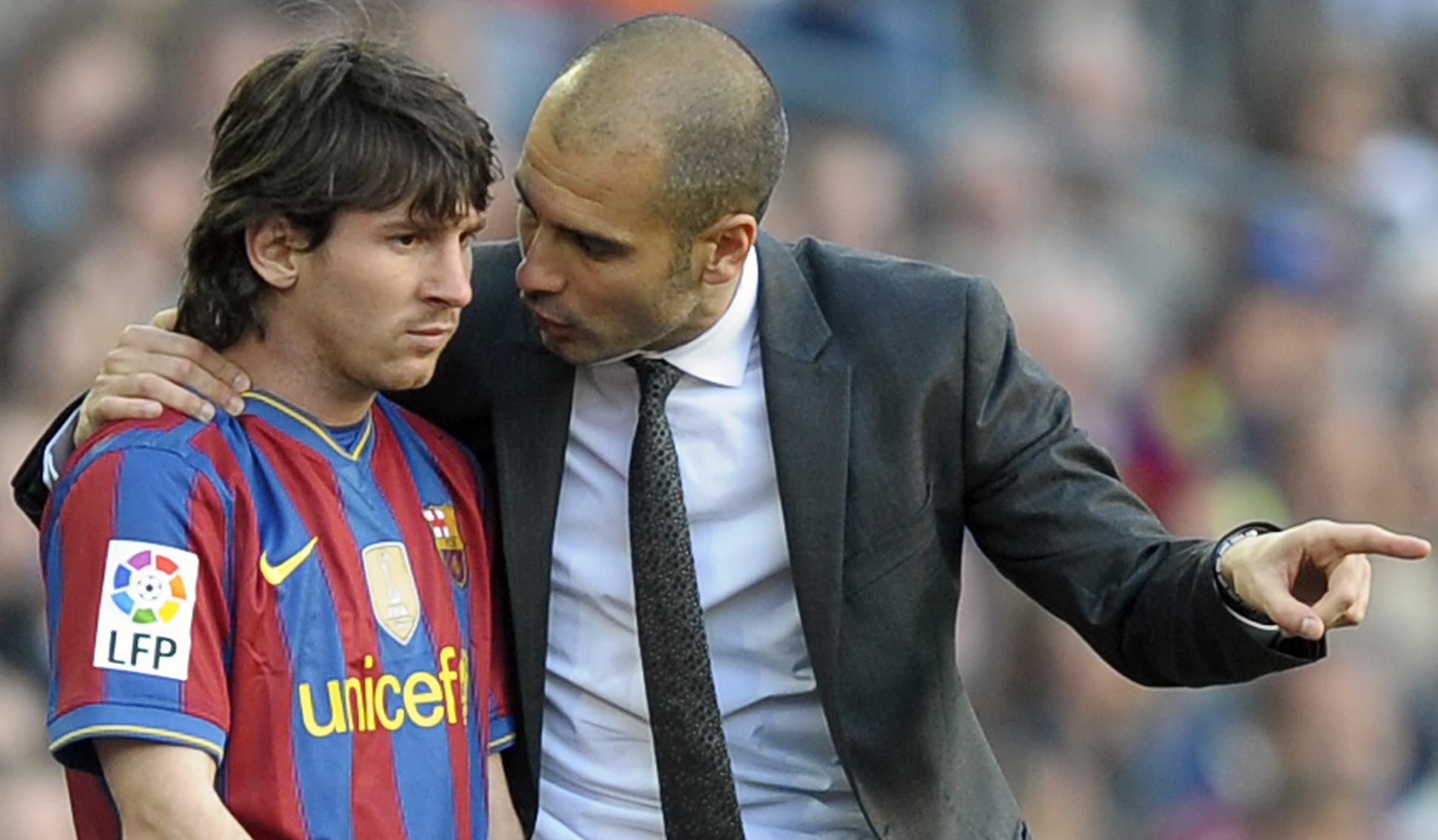 Barcelona's coach Pep Guardiola (R) talks with Barcelona's Argentinian forward Lionel Messi during the Spanish League football match between Barcelona and Jerez on April 24, 2010 at Camp Nou stadium.
