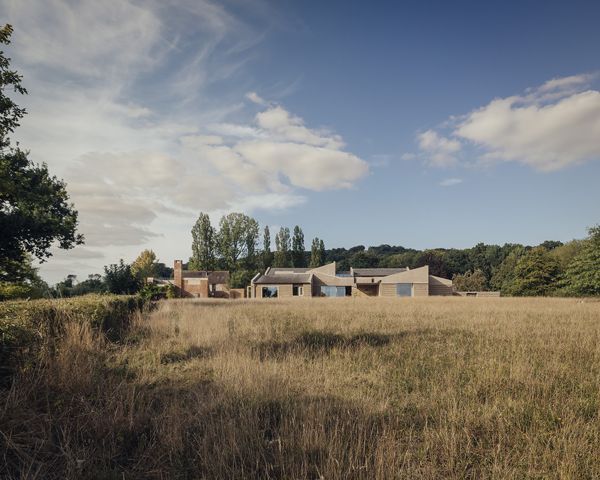 view of Rammed Earth House by Tuckey Design Studio with tactile walls and earth tones