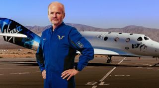 Virgin Galactic chief pilot Dave Mackay models his newly unveiled spacesuit in front of the company's VSS Unity space plane.