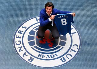 Joe Barton poses with a Rangers shirt