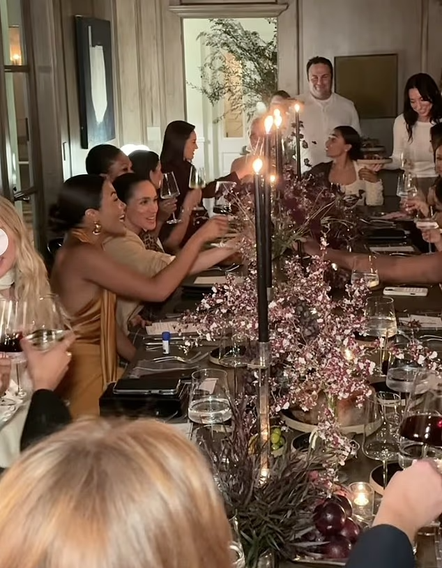 Meghan Markle and Emma Grede toasting at a dinner