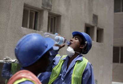 A Nepalese worker takes a break on the FIFA construction site