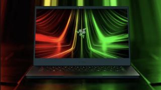 One of the best laptops for gaming is a Razer laptop, which is photographed against a neon red and green graphical background 