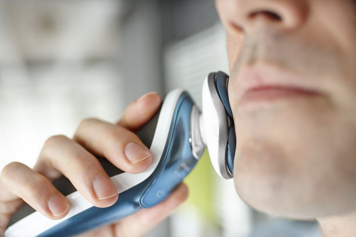 Man shaving with Philips Norelco Electric Shaver 7500 