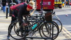 Woman locking up a bike in a busy area