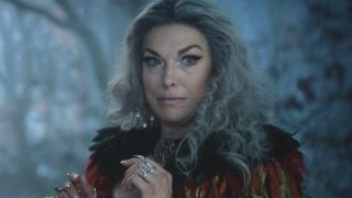 Hannah Waddingham stands in the woods with a look of mystery in Hocus Pocus 2.