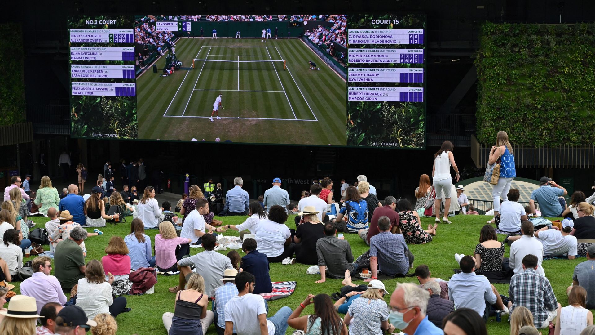 an image of a crowd of people watching a Wimbledon match in a public park space in London