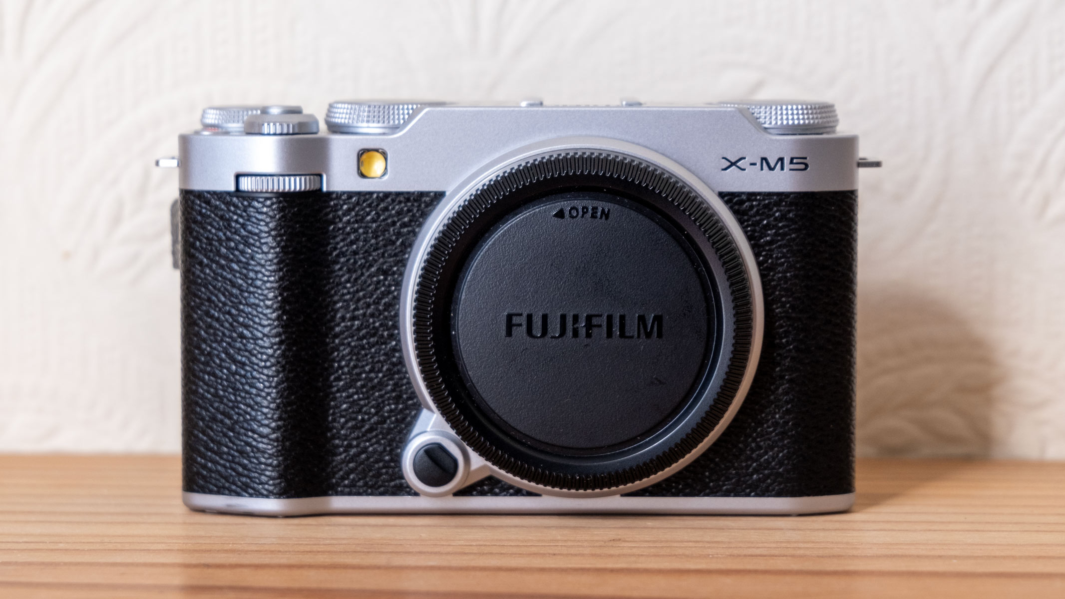 The front of the Fujifilm X-M5 with body cap attached.