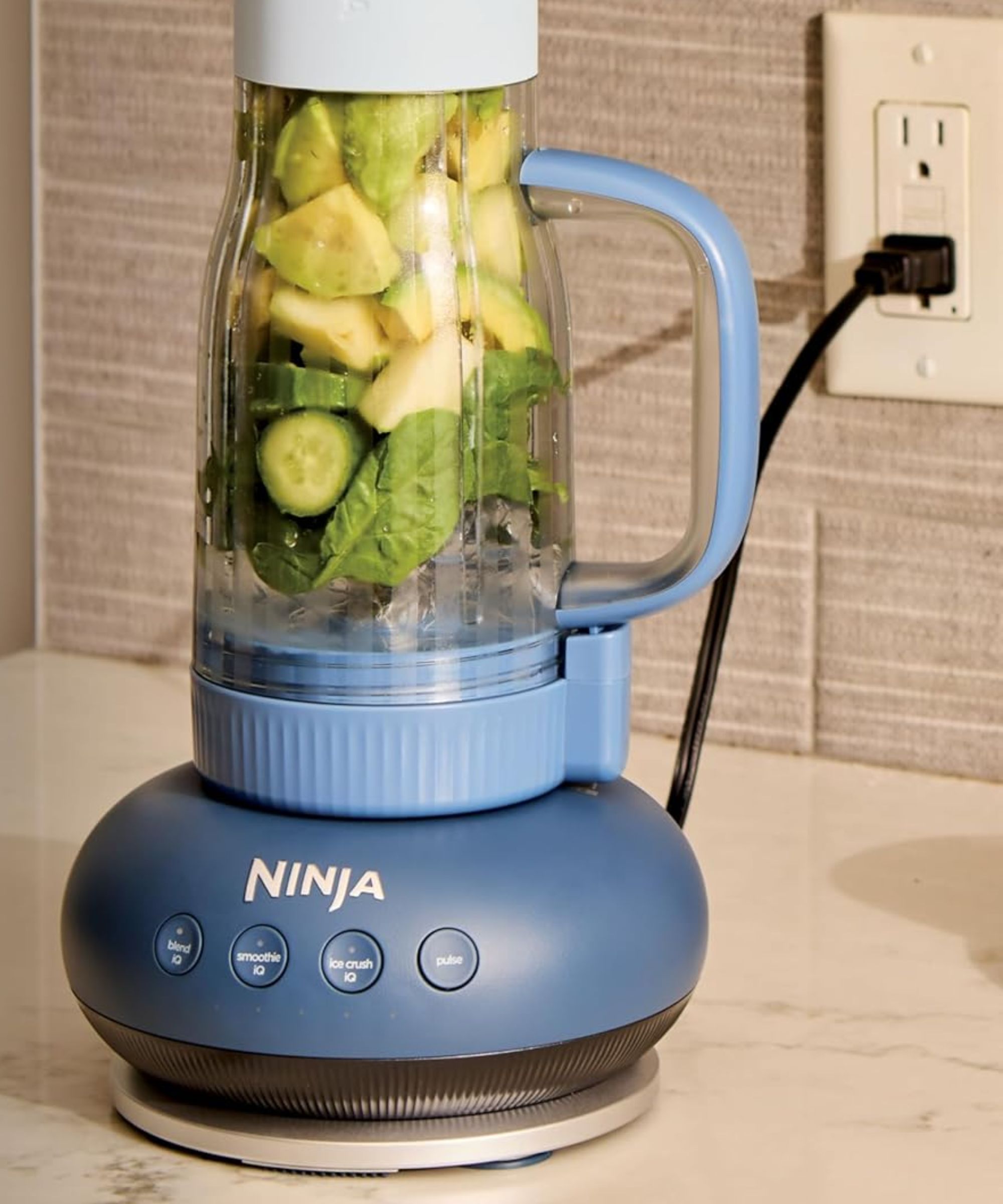 A blue ninja blendBoss tumbler blender on a kitchen counter.