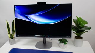 HP OmniStudio X 31.5 all-in-one PC on a desk in between house plants with pop-out webcam revealed