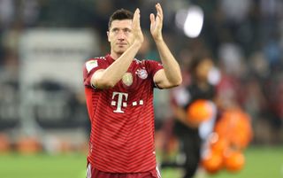 Bayern Munich striker Robert Lewandowski applauding the fans