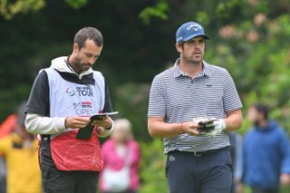 Nacho Elvira chats to his caddie during the final round of the Soudal Open