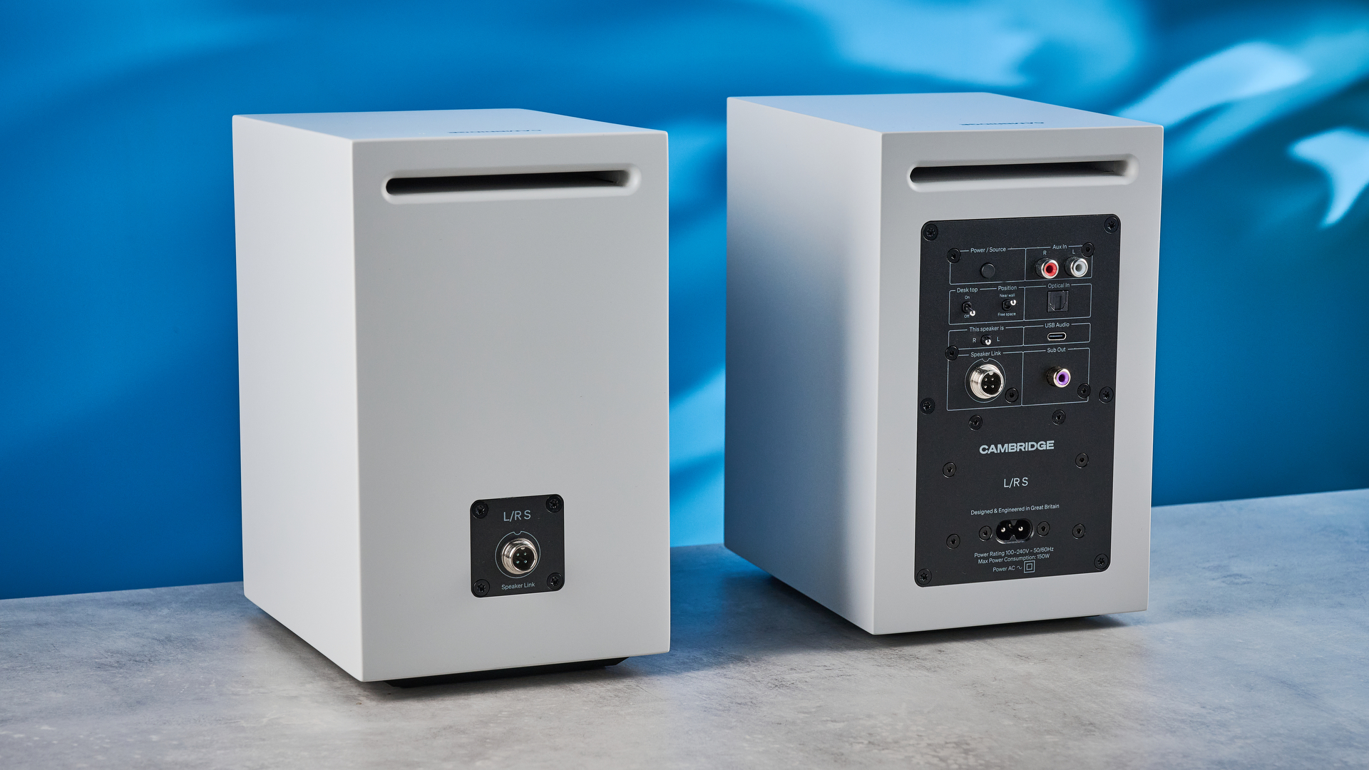 the cambridge audio l/r s bookshelf speakers in white with a 21mm aluminum tweeter and a 3-inch woofer photographed against the blue tom's guide background