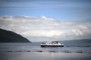 Tourists take in the sights as they travel by cruise boat on Loch Ness in the Scottish Highlands, Scotland on June 10, 2018