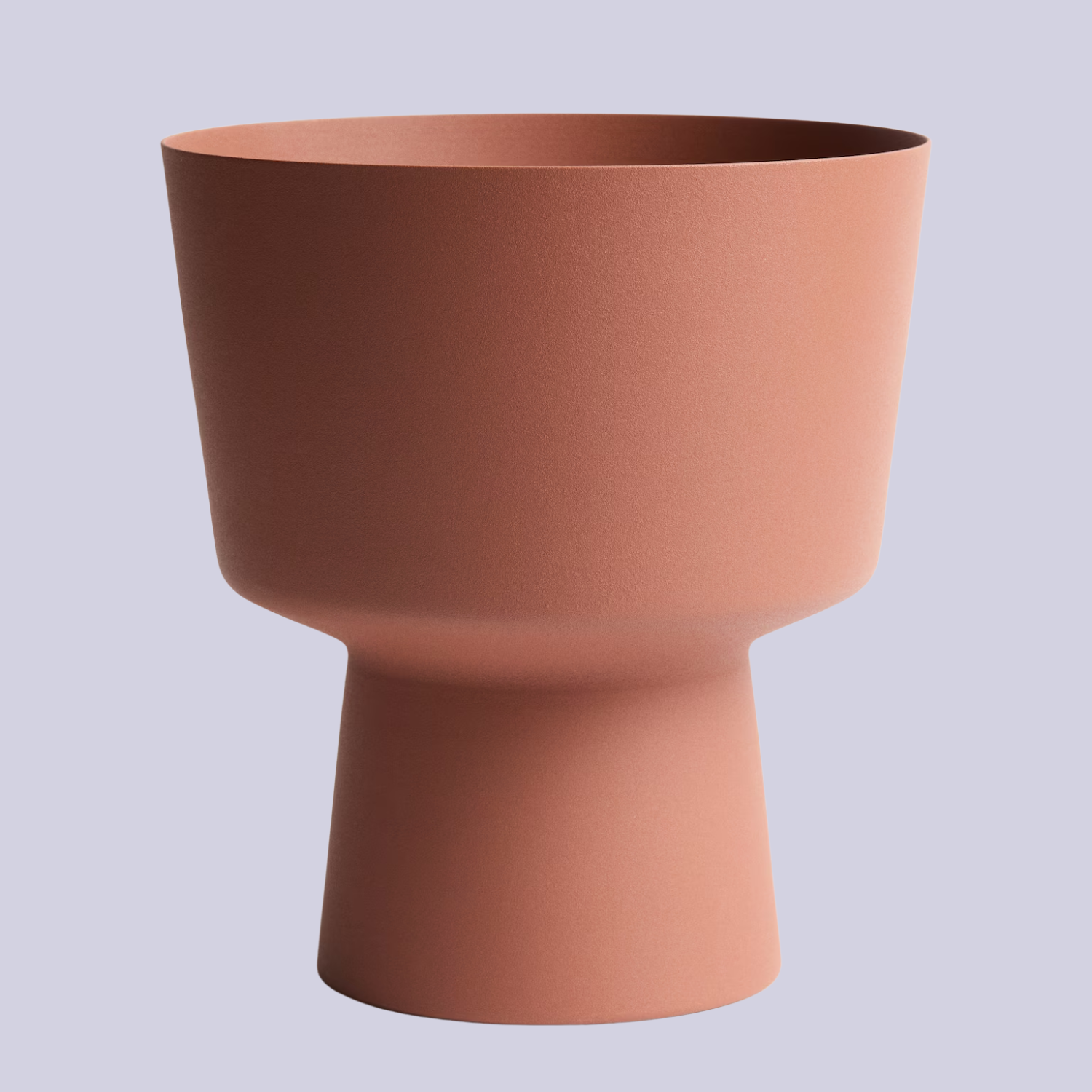 A metal terracotta-colored plant pot