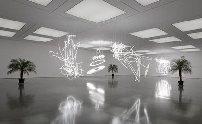 Hanging neon lights in large white room