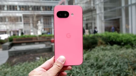 Google Pixel 9a held in the hand.