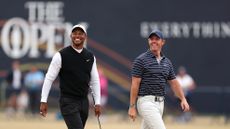 Tiger Woods and Rory McIlroy walk the fairway at St Andrews