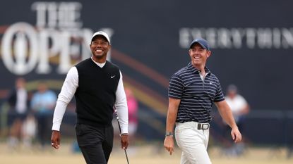 Tiger Woods and Rory McIlroy walk the fairway at St Andrews