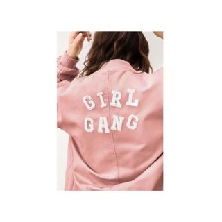 A wall artwork with a girl in a pink jacket that says 'girl gang'