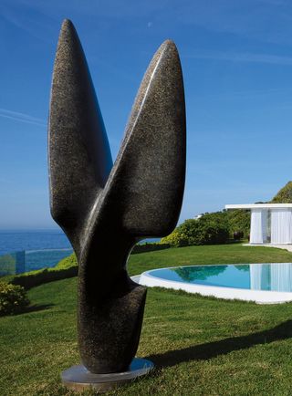 private residence with sculpture beside pool