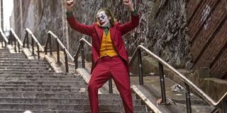 Joker dancing on the steps, in full costume and makeup