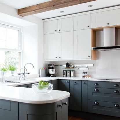 Blue kitchen with white countertops and white cabinets