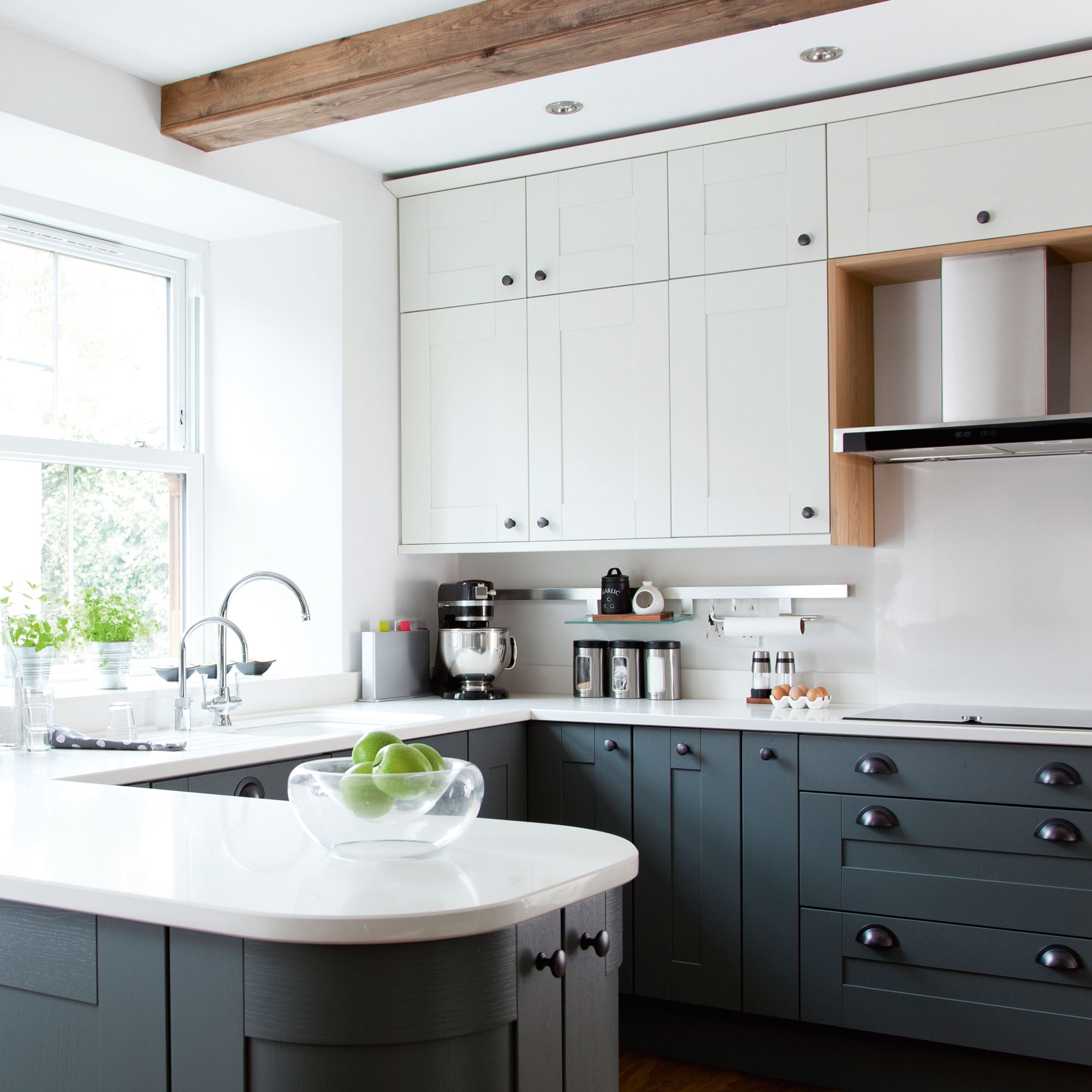 Blue kitchen with white countertops and white cabinets