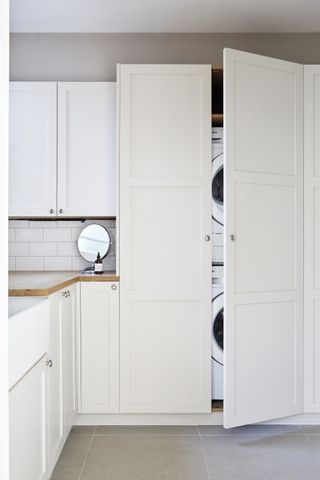 how to organize a laundry room stack your appliances, white laundry room by Naked Kitchens