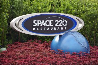 Themed signs direct guests to the entrance to the new Space 220 restaurant in the Mission: SPACE pavilion at Epcot.