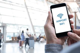person on Airport free Wi-Fi using a phone