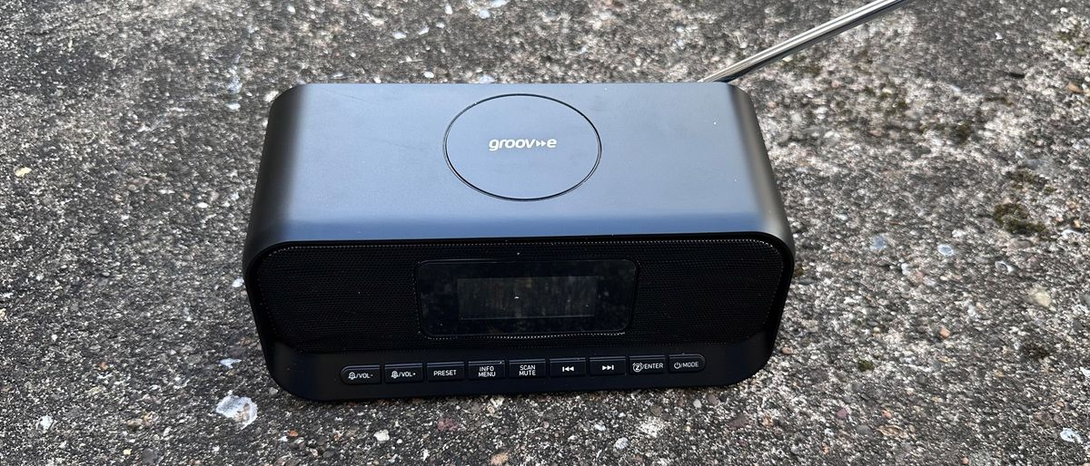 The Groov-E-Zeus DAB FM radio clock against cement 