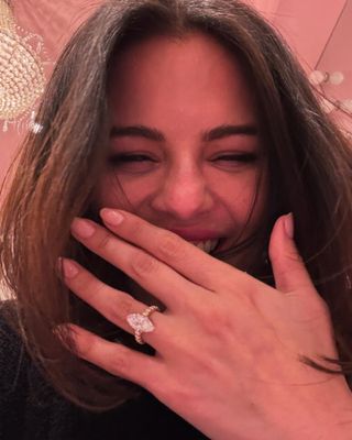 Selena Gomez showing off her new engagement ring from fiancé Benny Blanco. The ring features a large marquise-cut diamond and is set on a yellow-gold pavé band.