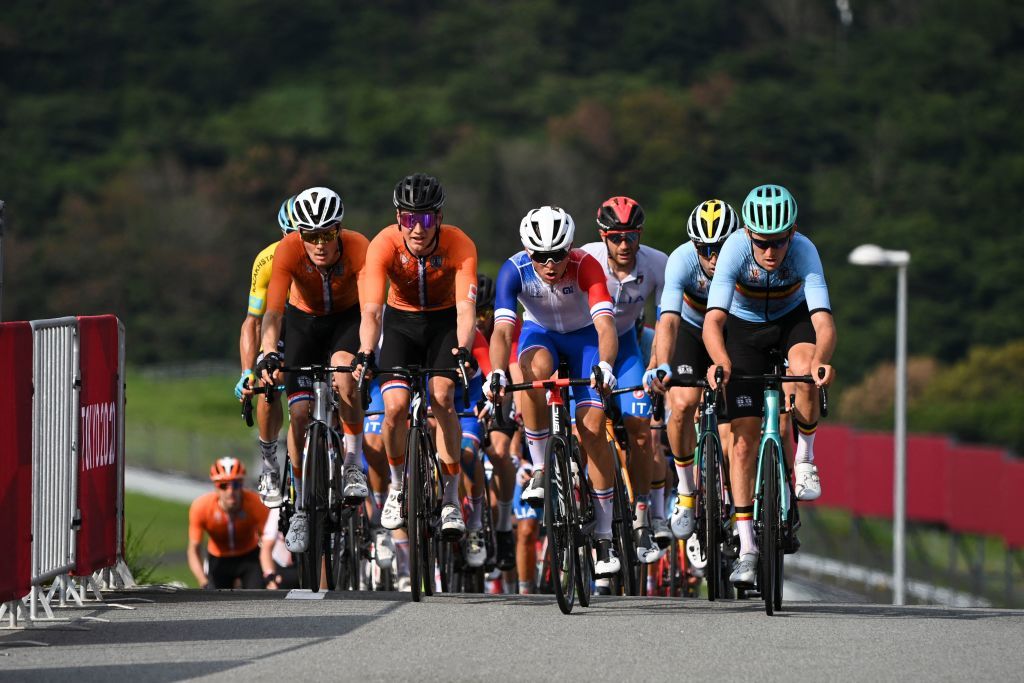 Cyclists ride in the peloton during the first lap of the Fuji International Speedway in the mens cycling road race of the Tokyo 2020 Olympic Games in Oyama Japan on July 24 2021 Photo by Greg Baker AFP Photo by GREG BAKERAFP via Getty Images
