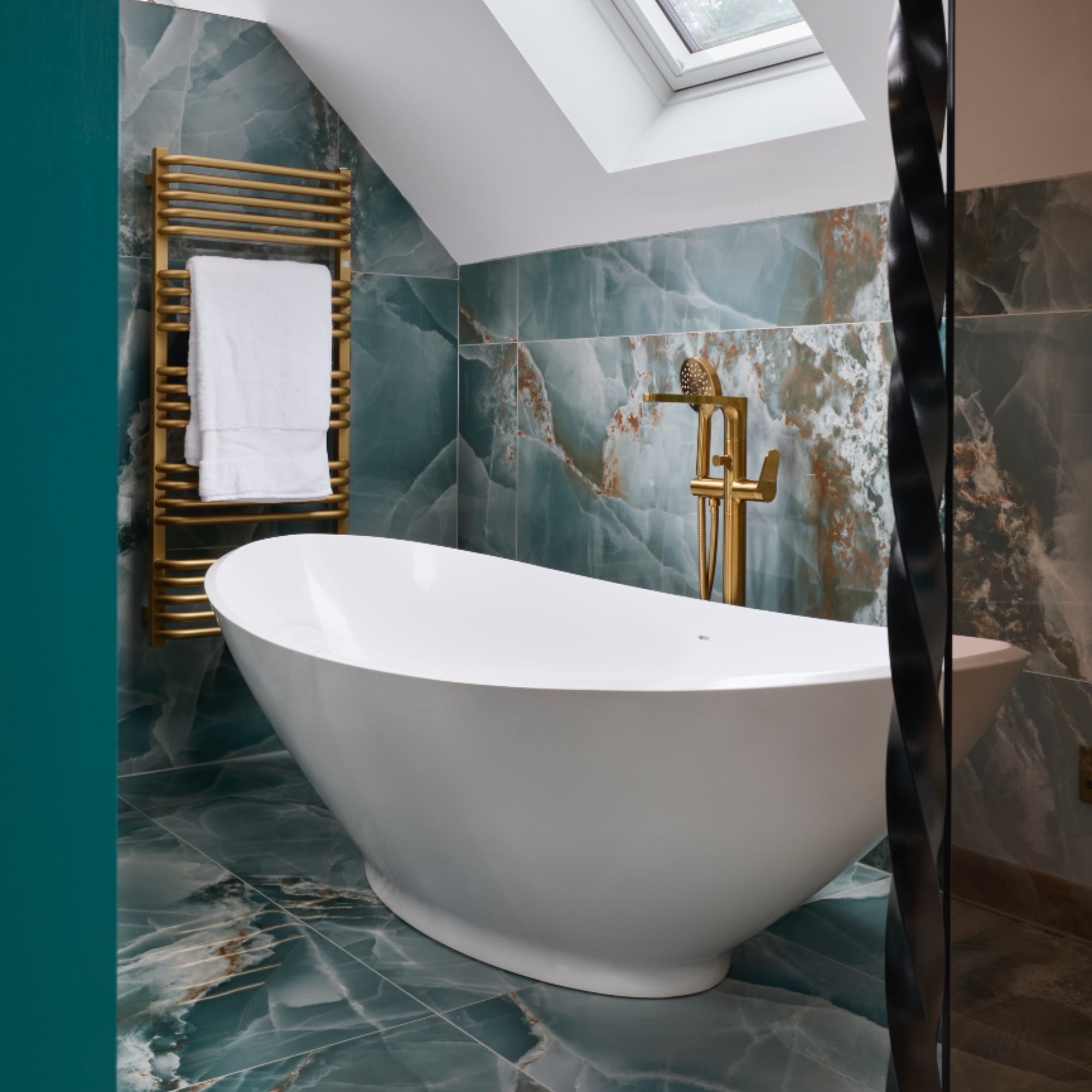 teal bathroom with modern bath, brassware, teal marble tiles