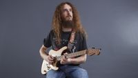 Guthrie Govan playing guitar sat on top of a Victory guitar amp