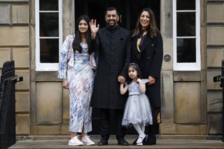 Humza Yousaf and his family waving from a doorstep
