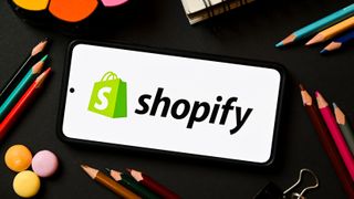 Illustration of a Shopify logo displayed on a smartphone