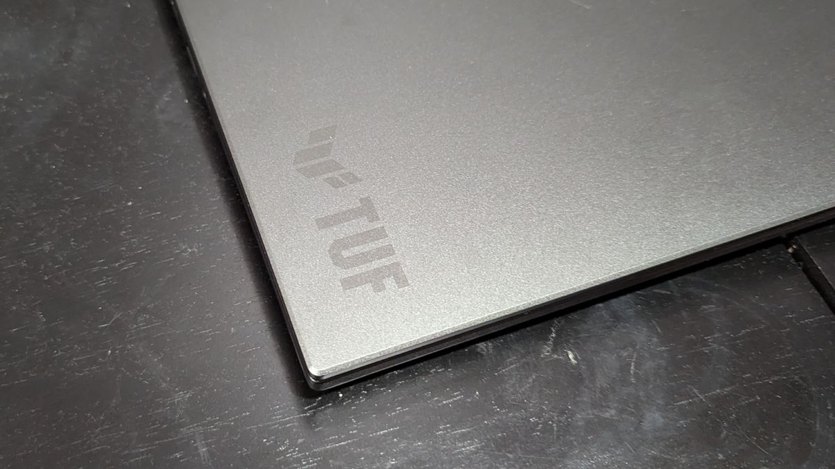 A close up of a laptop logo on the corner of a laptop lid.