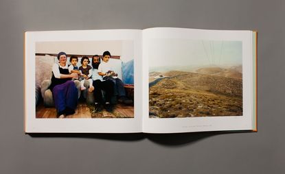 Family sitting on a couch next to a landscape image