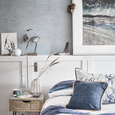 bedroom with blue wall and white cabinets 