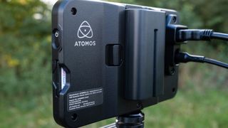 Close up of the logo of an Atomos Shinobi II camera monitor outside in a field