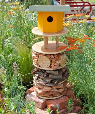 Bird house and insect hotel in a wildlife garden.