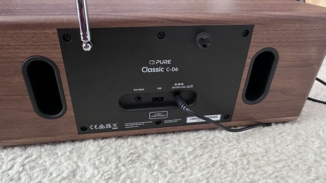 Pure Classic C-D6 DAB/FM Radio, CD player, Blueetooth speaker with a remote control on a carpet