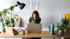 Woman working from home with the best desk lamps