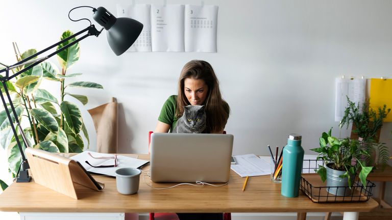 Woman working from home with the best desk lamps